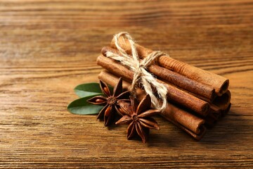 Aromatic cinnamon and anise stars on a wooden background