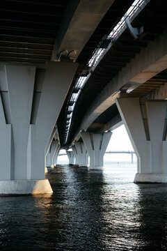 view from below of arches of suspension road. bridge over water, expressway against sky. Transport architecture, engineering construction. western high-speed diameter
