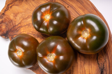 Fresh ripe sweet reddish brown and green kumato tomatoes close up