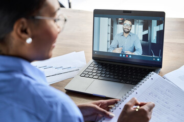 Professional African business woman manager executive working on laptop having video conference...