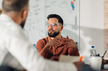 Businessman explaining strategy to colleagues during office meeting