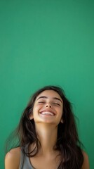 Fototapeta premium beautiful girl beautiful young woman smiling on green background with copy space vertically 9:16