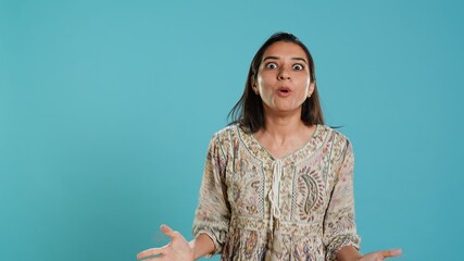 Portrait of joyful indian woman celebrating, showing positive emotions, feeling happy. Delighted...