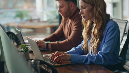 Busy employees working computers at office closeup. Two colleagues focused