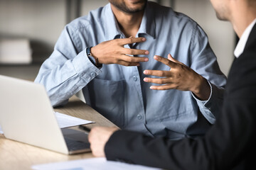 Two male colleagues engaged in business strategy discussion, collaborate on problem-solving, close...