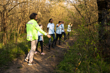 Fototapeta premium As the mission for the missing person grows worse, supervisor of the rescue operation team leads his crew into the woods in search of evidence. People shouting for the lost civilians name.