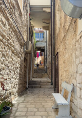 Korcula, Croatia - June 30, 2024: Look from the west into the street, alley with steps named Rafa Anerija. Colored laundry overhead © Klodien