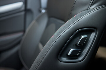 Obraz premium Explore the intricate functions of premium luxury car seat control buttons in detail