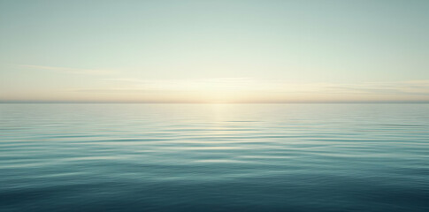 Fototapeta premium A serene ocean view at sunrise, showcasing calm waters and a soft horizon.
