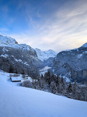 Scenic view of Lauterbrunnen Valley, Switzerland seen from Wengen with snowcovered Breithorn mountain in winter against blue sky with clouds