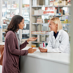 Woman, pharmacist and advice in pharmacy with box, medication or pill recommendation. Happy...