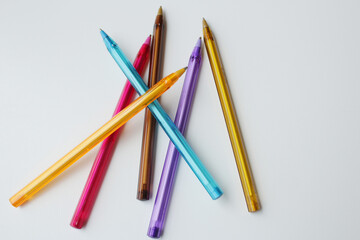 Group of scattered colorful pens on white background. Color stationery, school supplies, art lesson, drawing class, creativity concept.