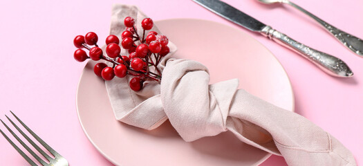 Beautiful Christmas table setting with rowan on pink background