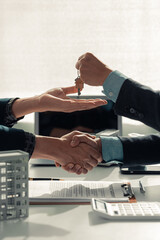 Real estate agent delivers keys and customers sign sales contracts and provides advice on house and...