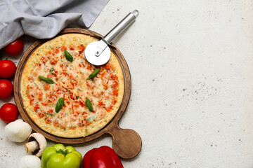 Tasty pizza, cutter and ingredients on light background