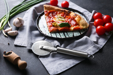Composition with tasty pizza and cutter on dark background