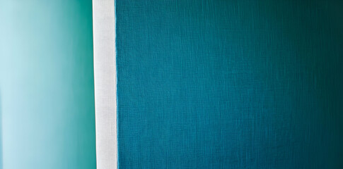 Fototapeta premium A minimalist image featuring a textured wall in shades of teal and a white edge.