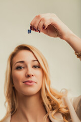 Fototapeta premium Woman holding a small gift expressing different emotions and fee
