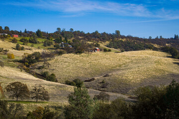 Landscape photo of hillside with red barn taken at Hidden Falls Regional Park in the Sierra Nevada...