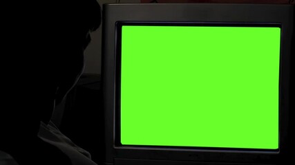 Silhouette of Primary School Child Using Green Screen Computer in Dim Classroom - Close Up - Powered by Adobe