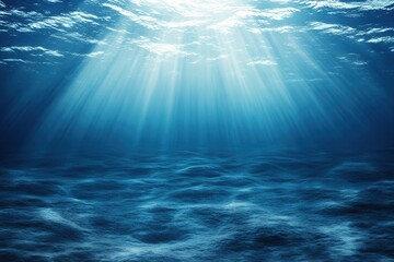 Obraz premium Underwater scene with light rays illuminating the ocean.
