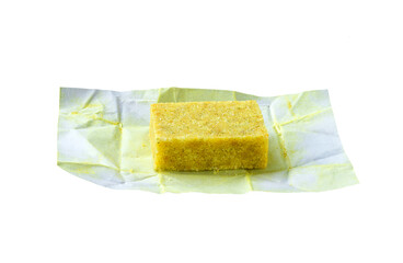 Unwrapped bouillon cube on white background. Broth concentrate isolate.