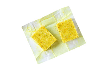 Unwrapped bouillon cube isolated on a white background.