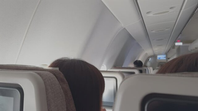 Airplane Cabin View with Passengers Communicating