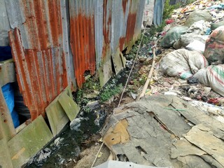 a water ditch filled with garbage