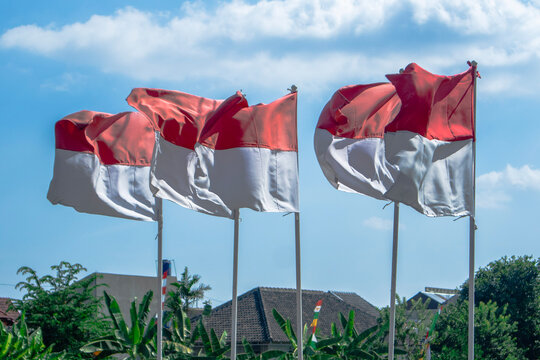 Yogyakarta, Indonesia - 17 August, 2024: The red and white flag flutters due to the strong wind during the day