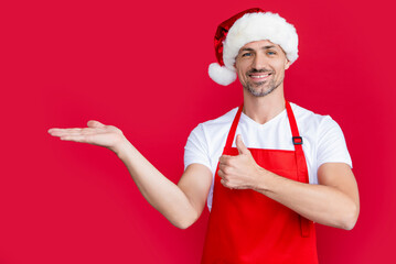 happy mature man in red householder apron and christmas santa hat