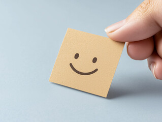 Obraz premium Hand choosing happy smile face paper cut, good feedback rating and positive customer review, mental health assessment, child wellness, world mental health day, think positive, compliment day concept