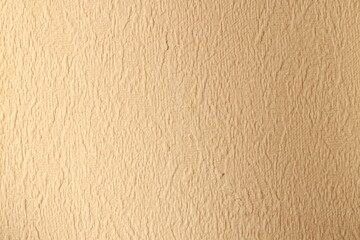 Textured Beige Wall Surface Ideal for Various Background Use in Design and Decor Projects