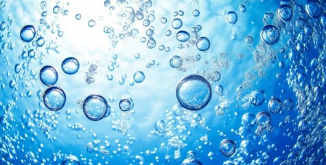 Underwater scene with many air bubbles rising towards bright light.