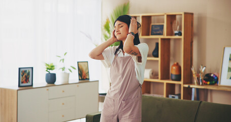 Girl, dancing and listening to music in living room, relax and eyes closed with subscription in home. Woman, person and dancer with streaming services for audio, tech and rhythm with sound at house