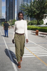 Fototapeta premium Confident Woman in Stylish Casual Outfit Posing in an Urban Setting