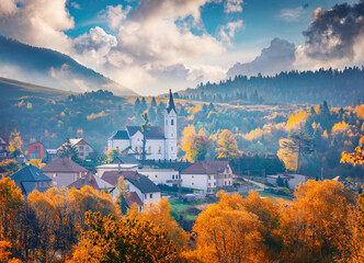 Long phocus picture of Catholic church of St. Michael the Archangel. Autumn scene of Valaska...