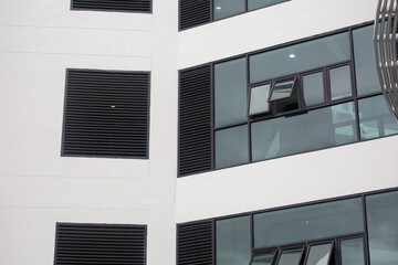 The building's black-rimmed glass windows are letting in the breeze.