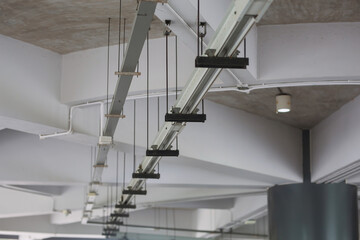 Naklejka premium Electrical system and CCTV cameras, fire pipes are installed under the building ceiling.
