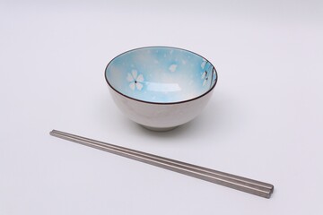 Bowl and chopsticks isolated white