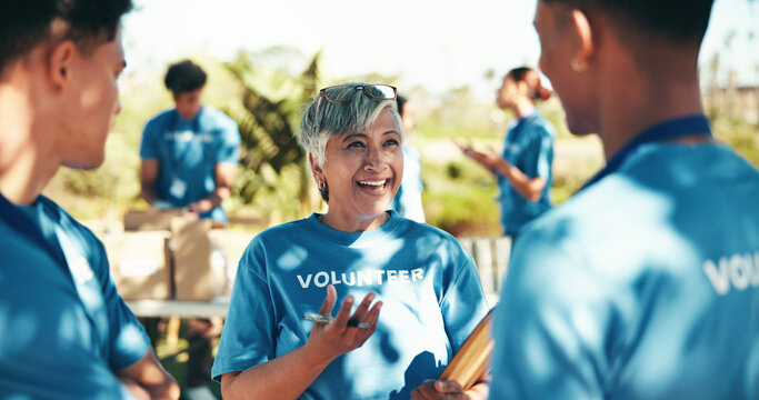 Teamwork, volunteers and happy for charity, group and success of fundraiser, discussion and mature woman. Outdoor, talking and coordinator with good news for people, community service and nonprofit - Powered by Adobe