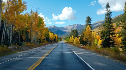 Obraz premium Serene Autumn Drive Through Golden Aspens and Majestic Mountains