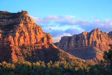 The mountains are covered in red rocks and the sky is a beautiful shade of blue