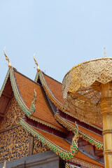 Ancient Thai temple roof with intricate carvings, a testament to the rich cultural heritage of...