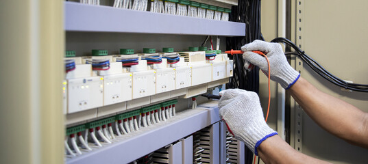 Electrical engineer inspects electrical control equipment
