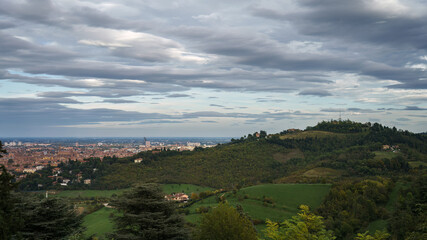 Panoramic view of Bologna, Italy surrounded by green hills