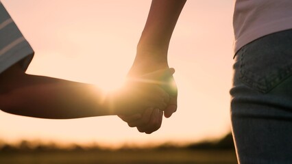 child holding mother hand sunset, happy childhood dream, happy family, hands at sunset family,...