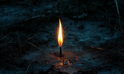 Small flame burns dimly on dark ground.
