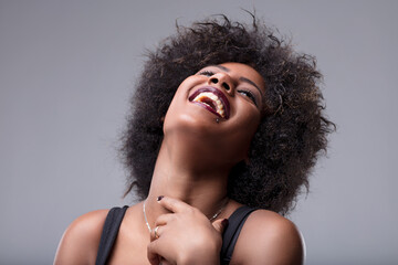 Young woman laughing with head tilted back