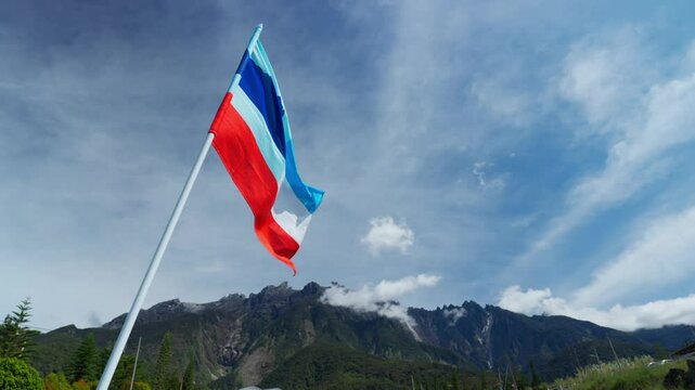 Sabah flags in the wind in front of mount kinabalu  (slow motion)